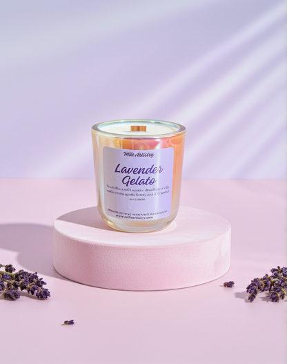 Candle labeled 'Lavender Gelato' on a pink platform with lavender flowers around, against a light purple background.