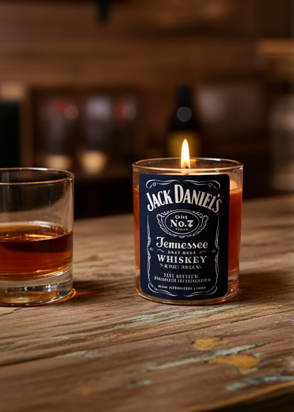 Jack Daniel's candle and glass of whiskey on a wooden surface with blurred background