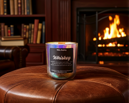 Candle labeled 'Whiskey' on a leather ottoman with a fireplace in the background
