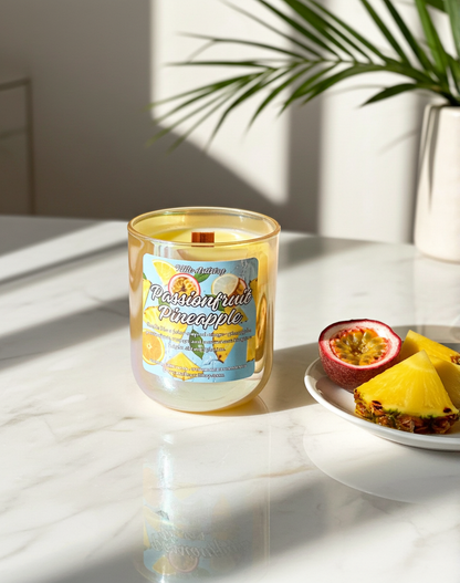Candle labeled 'Passionfruit Pineapple' on a marble surface with a plate of fruit.