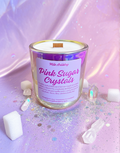 Candle labeled 'Pink Sugar Crystals' on a glittery surface with decorative crystals around.