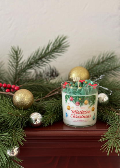 Decorative candle with Christmas design on a mantel with festive decorations.