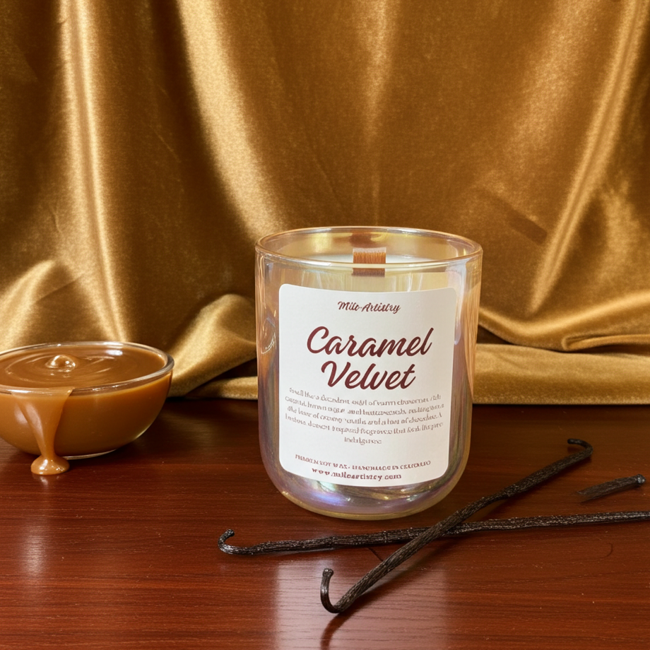 Candle labeled 'Caramel Velvet' with vanilla beans and a bowl of caramel on a gold fabric background