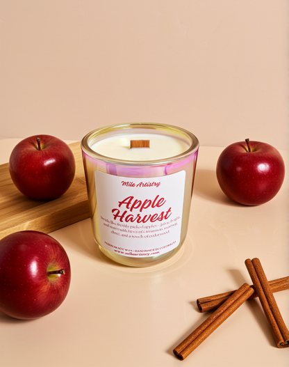 Candle labeled 'Apple Harvest' with apples and cinnamon sticks on a beige background