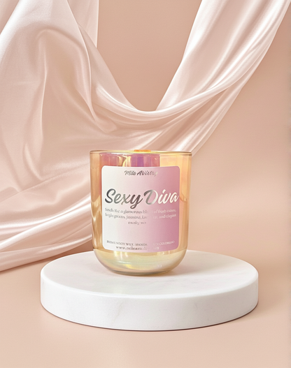 Candle labeled 'Sexy Diva' on a white platform with pink fabric in the background